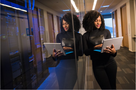 Woman using computer in server room